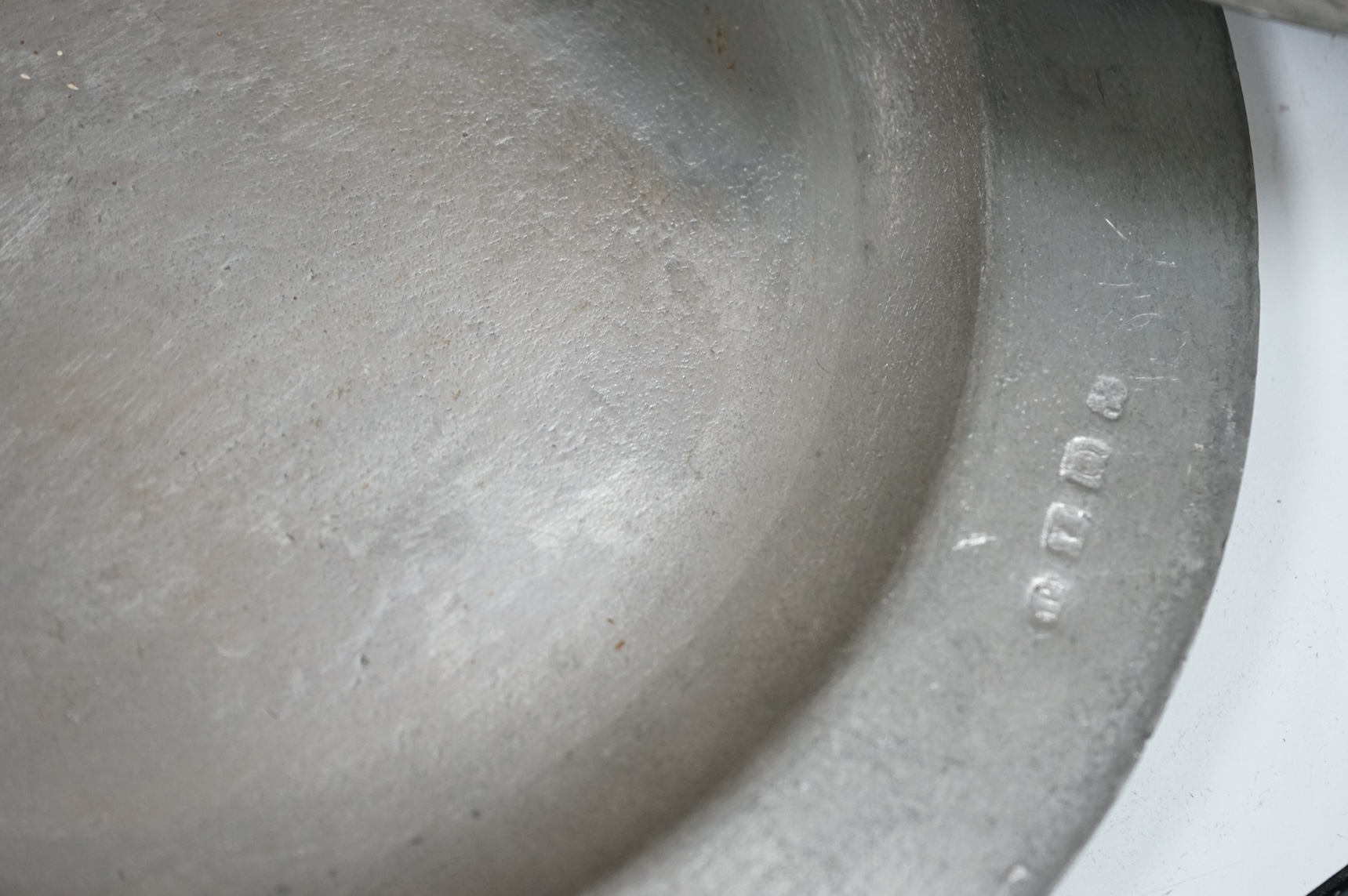 Two 19th century pewter chargers and a set of six pewter plates, largest 42cm in diameter